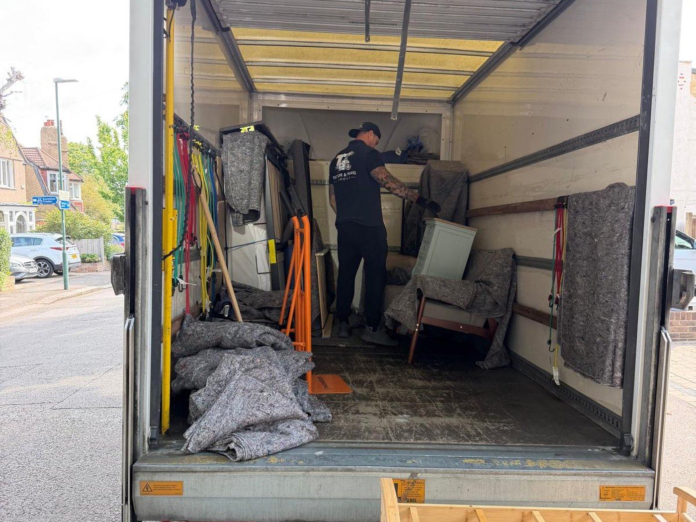 Loaded removal van interior with furniture secured and wrapped