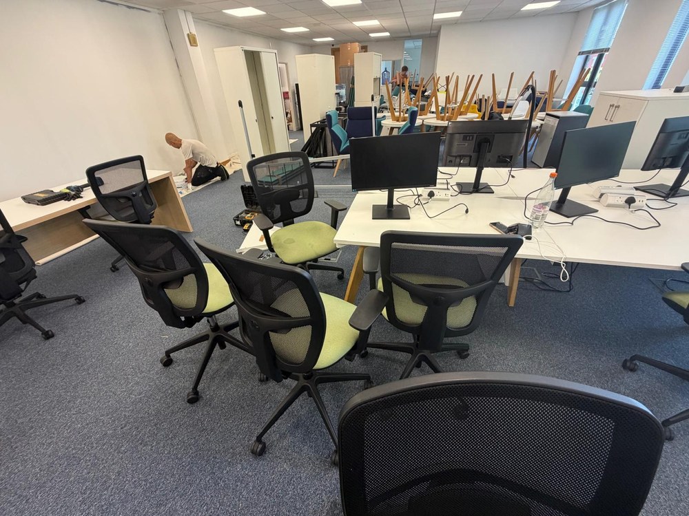 Office desks and chairs part-way through a relocation