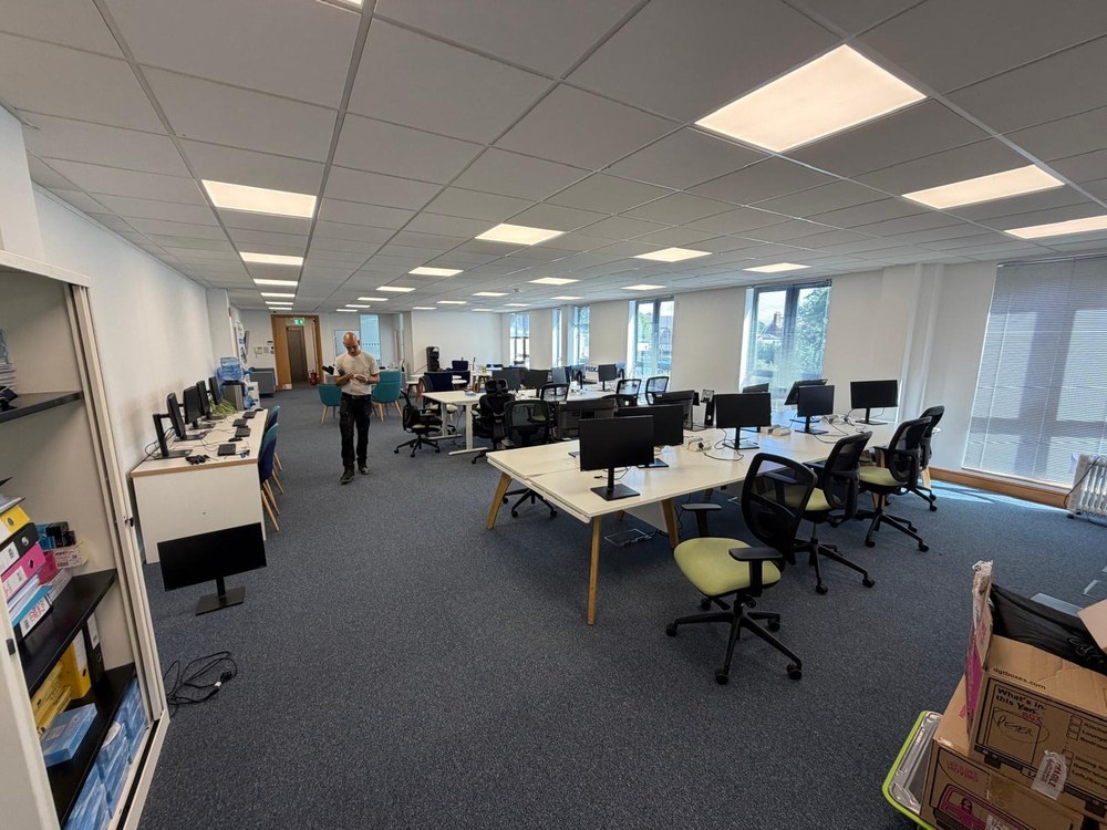 Open-plan office with desks and monitors before a commercial move