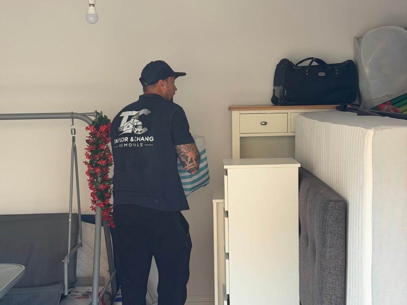 Taylor & Chang crew member moving a wardrobe unit in a garage