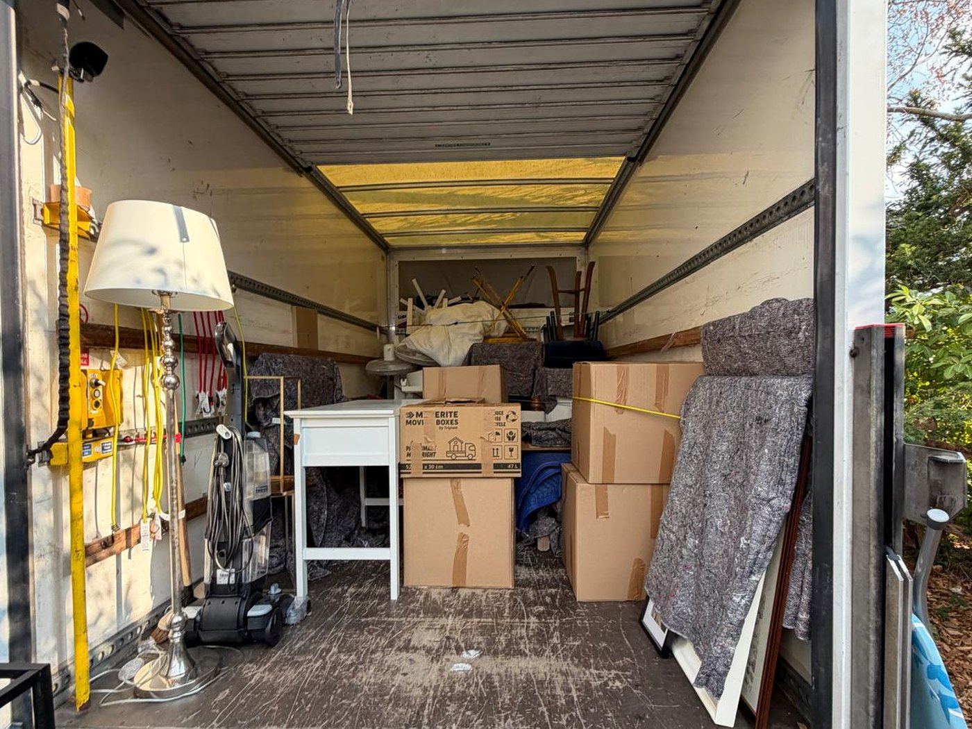 Removal van loaded with packed boxes and protective blankets
